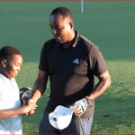 Golf father and Son respect, Chris Nyagah, shakes son Jeremiah's hand at the 18th tee