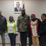 Kenyans in New York pose for a photo after registering to vote at the NYC consulate office