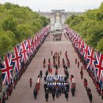 The procession makes its way along the UK flags