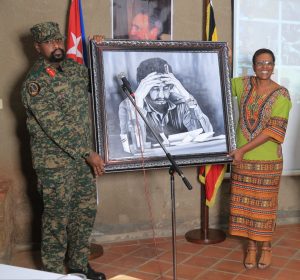 Holding a framed drawing of Cuba's Fidel Castro