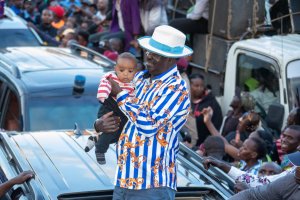 Azimio leader Raila Odinga holds a baby during a protest rally saying he is fighting for the future generation