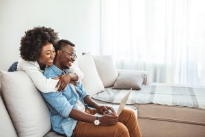 Happy couple working from home