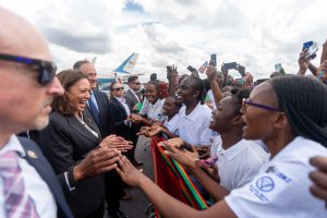 Vice President Kamala Harris gives her signature jovial laughter while meeting school girls while on a trip to Africa