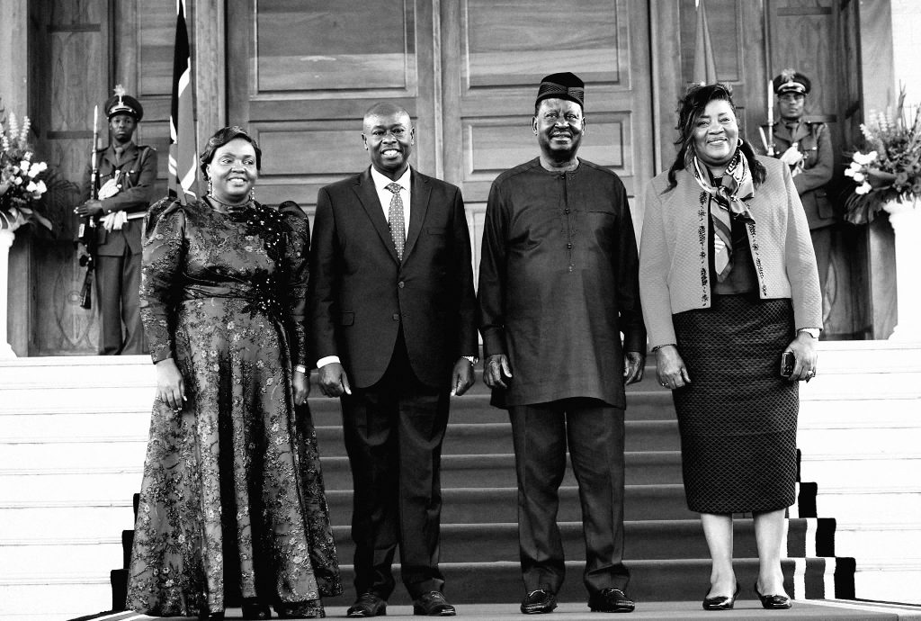 Former Deputy President Rigathi Gachagua and the late Raila Odinga pose for a photo with their spouses.